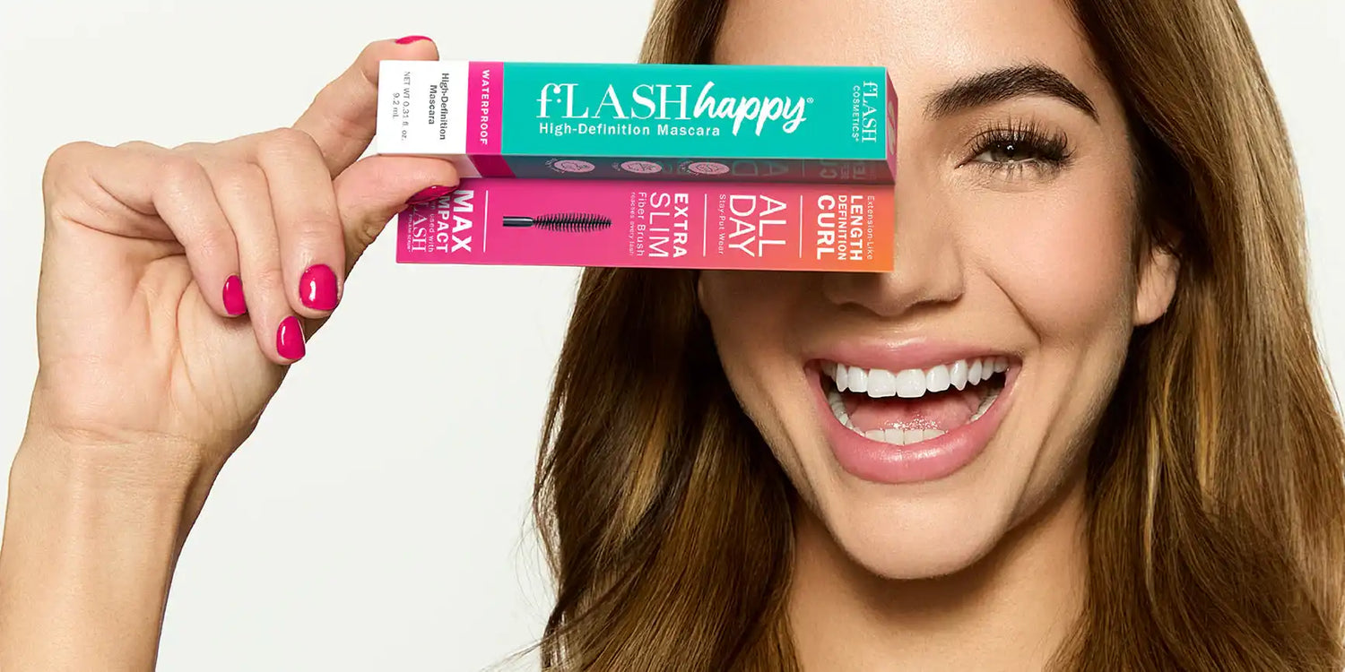 Smiling woman holding colorful mascara boxes labeled fLASH happy high-definition waterproof mascara