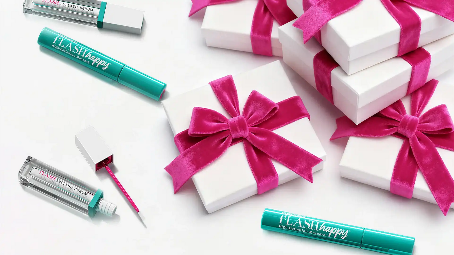 fLASH Cosmetics eyelash serum and mascara with white gift boxes tied with pink velvet ribbons
