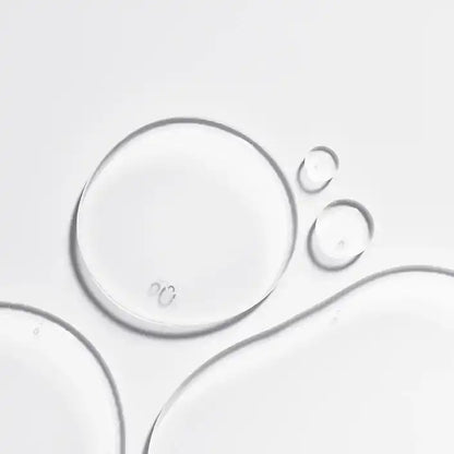 Clear serum drops on white background, fLASH Cosmetics eyelash serum texture